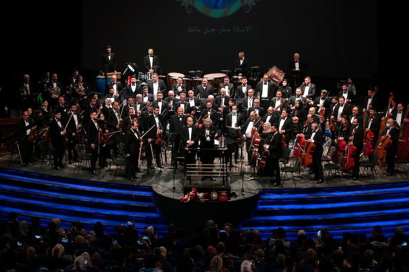 Mohammed Ameen, center, the chief conductor and director of the Iraqi National Symphony Orchestra acknowledges applause from the audience at the end of a performance at the Iraqi National Theatre in Baghdad, Iraq.  AP Photo