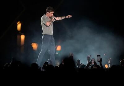 Fans wave to Liam Payne as he performs at the King Abdullah Sports Stadium, in Jeddah, Saudi Arabia, during the concert of Jeddah World Fest, late Thursday, July 18, 2019. Janet Jackson, Chris Brown, 50 Cent, Future and Tyga have been added to the lineup for the concert in Saudi Arabia that Nicki Minaj pulled out of because of human rights concerns.(AP Photo/Khalid Alhaj)