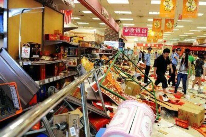 Security guards try to remove a group of Chinese protesters who ransacked Japan's Jusco departmental store, in Qingdao, northeast China.