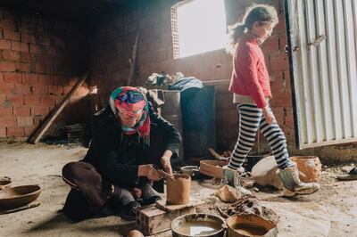 The craft of Sejnane pottery is passed down from generation to generation. Eljia Ayari learned the art from her mother and grandmother, and is teaching it to her daughters and granddaughters. Erin Clare Brown / The National