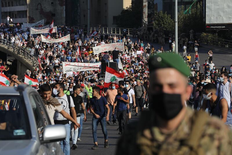 BEIRUT, LEBANON - OCTOBER 17: Lebanese army vehicles escort crowds walking over a bridge linking the city on the one-year anniversary of anti-government protests on October 17, 2020 in Beirut, Lebanon. On the one year anniversary since the unprecedented mass protests of Lebanese demanding political change as the country buckled under social and economic devastation, Beirut remains in rubble after the August 4 port blast. (Photo by Marwan Tahtah/Getty Images)