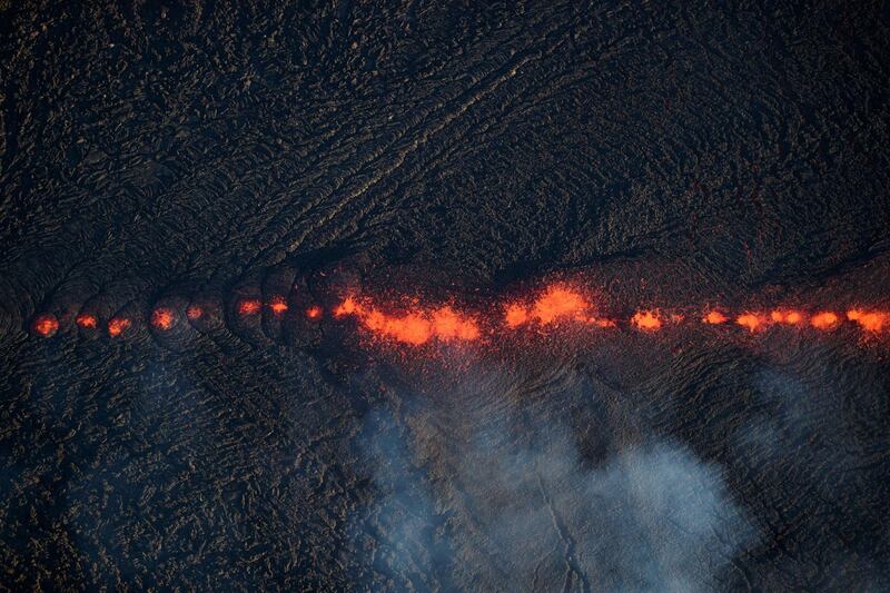 An aerial view shows fissure 17 continuing to erupt, creating wide, a mile long flow of lava that now threatens homes, property, and two major thoroughfares in Pahoa, Hawaii on 14 May, 2018. Bruce Omori / EPA