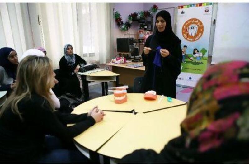 Dr Sumaia Al Rubaee, from Tawam Hospital, trains school nurses at Al Afaq Model School on pupils' dental health and hygiene. Fatima Al Marzouqi/ The National