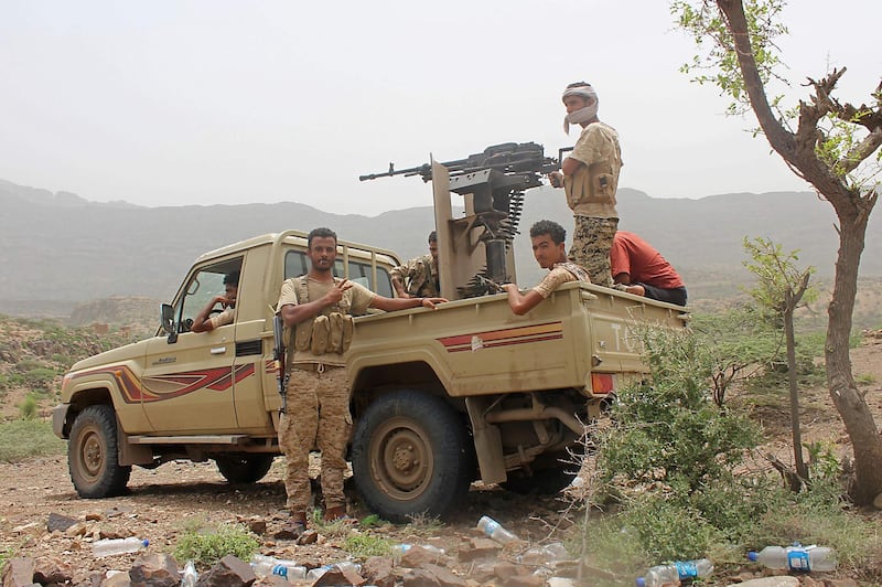 Yemeni pro-government fighters sit at the back of an armed pick-up as Emirati supported forces take over Huthi bases on the frontline of Kirsh between the province of Taez and Lahj, southwestern Yemen, on July 1, 2018. The United Arab Emirates on Sunday announced it had halted the offensive it is backing against Huthi rebels in Yemen's port city of Hodeida to give a chance to UN diplomatic efforts.
 / AFP / Saleh Al-OBEIDI
