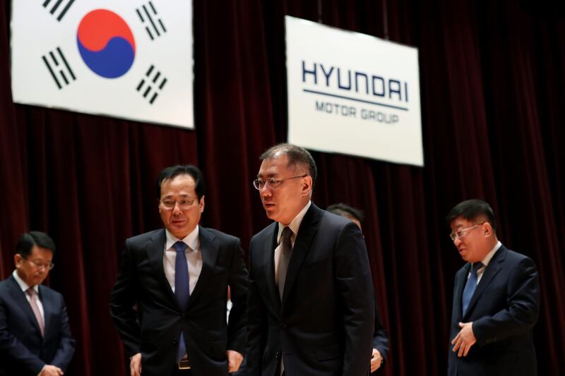 Chung Eui-sun, vice chairman of Hyundai Motor Co., center, leaves a new year company meeting at the automaker's headquarters in Seoul, South Korea, on Tuesday, Jan. 2, 2018. South Korea’s biggest automaking group, which faced a consumer backlash in China last year over tensions between the two countries, forecast a slowdown in sales in 2018 as political risks dent demand for its vehicles in the world’s major markets. Photographer: SeongJoon Cho/Bloomberg