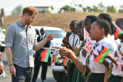 FILE - In this Sunday, Sept. 29 2019 file photo, Britain's Prince Harry arrives at the Nalikule College of Education to learn about the CAMA network and how it is supporting young women in Malawi on day seven of the royal tour of Africa in Lilongwe, Malawi. The final day of Prince Harry and his wife Meghanâ€™s 10-day visit to Africa with infant son Archie in tow has been overshadowed by a lawsuit she has filed against Britainâ€™s Mail on Sunday tabloid. (Dominic Lipinski/Pool Photo via AP, File)