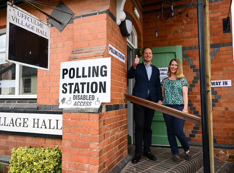 Liberal Democrat candidate Richard Foord and his wife Kate pose for photos outside the village hall polling station after casting their votes for the Tiverton and Honiton by-election. Getty Images