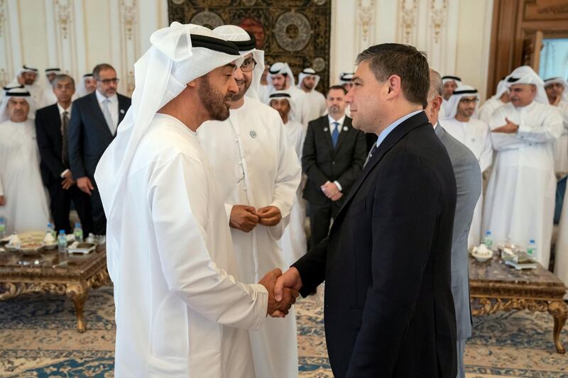 ABU DHABI, UNITED ARAB EMIRATES - October 08, 2018: HH Sheikh Mohamed bin Zayed Al Nahyan Crown Prince of Abu Dhabi Deputy Supreme Commander of the UAE Armed Forces (L), receives Lorenzo Simonelli, Chairman, President & CEO of Baker Hughes (R), during a Sea Palace barza. Seen with HE Dr Sultan Ahmed Al Jaber, UAE Minister of State, Chairman of Masdar and CEO of ADNOC Group (back center).

( Hamad Al Kaabi / Crown Prince Court - Abu Dhabi )
---