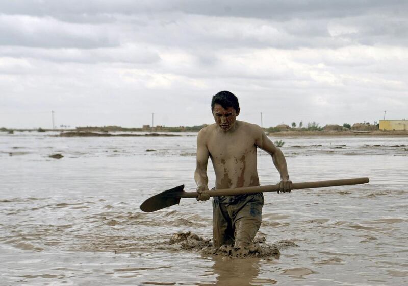An Afghan man searches for his belongings after flash floods at Jowzjan province in northern Afghanistan. Reuters