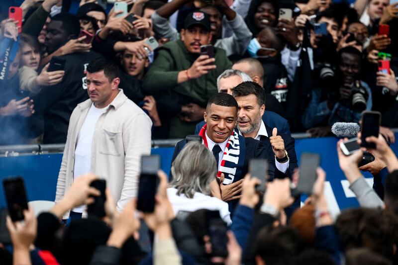 Kylian Mbappe gives a thumbs up to supporters outside the Parc des Princes. AFP