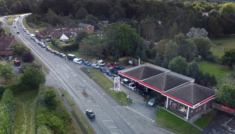 Motorists queue for fuel at a petrol station in Ashford, Kent, England on Wednesday. A government minister said the number of empty stations has halved since the weekend. AP