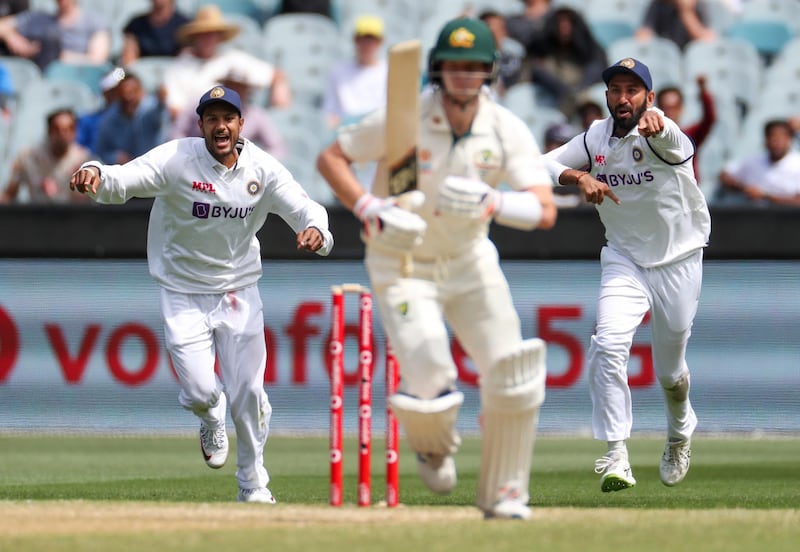 Indian players react as they celebrate the dismissal of Australia's Steve Smith. AP