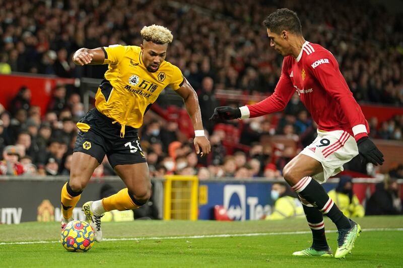 Wolves' Adama Traore runs at Manchester United Raphael Varane during the Premier League soccer match at Old Trafford on January 3, 2022. AP