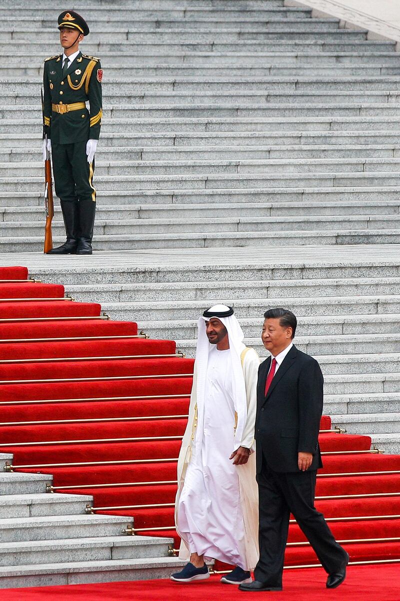 Abu Dhabi's Crown Prince, Sheikh Mohammed bin Zayed Al Nahyan, left, and Chinese President Xi Jinping walk by an honor guard during a welcome ceremony at the Great Hall of the People in Beijing, Monday, July 22, 2019. (AP Photo/Andy Wong)