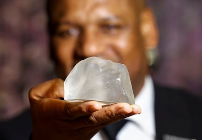 Pule Musi, a staff member, shows a replica of the Cullinan Diamond, the largest gem-quality rough diamond, displayed at the Cape Town Diamond Museum, in Cape Town. Reuters 
