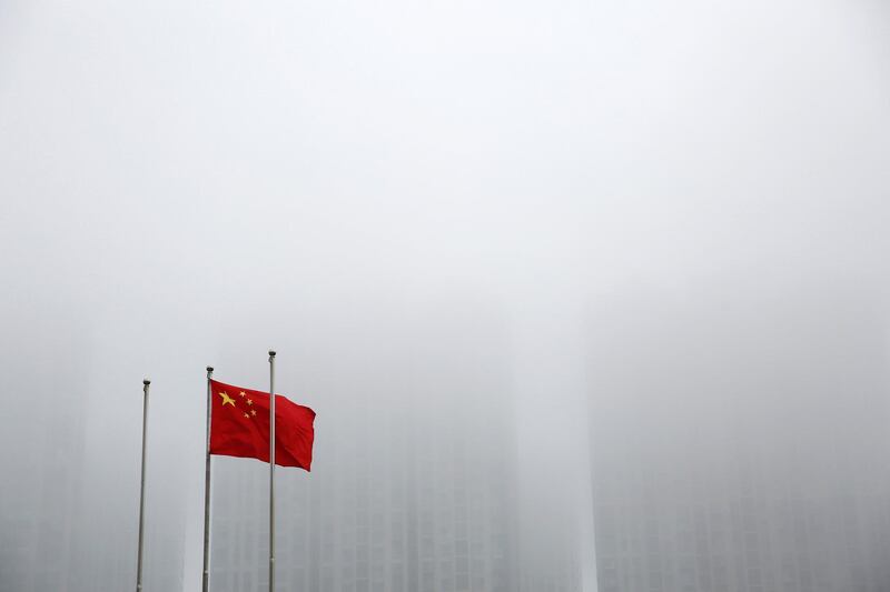 A Chinese flag is seen at a hazy day at the Shanghai Cooperation Organization (SCO) summit media center, in Qingdao, Shandong Province, China June 8, 2018. REUTERS/Aly Song