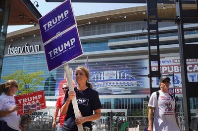 Supporters of Donald Trump carry signs around the site of the first Republican presidential debate in Milwaukee, Wisconsin. AFP