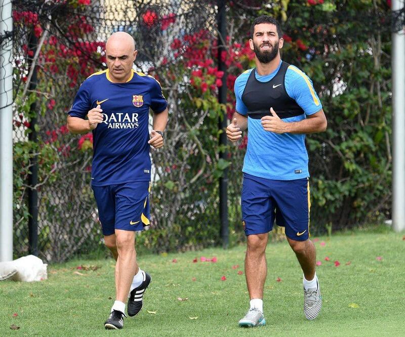 Arda Turan of Barcelona goes through a jogging session with a team trainer on Monday ahead of an International Champions Cup pre-season friendly against the LA Galaxy. Mark Ralston / AFP