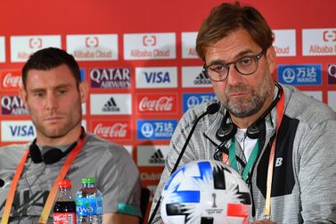 Liverpool FC coach Jurgen Klopp (R) and midfielder James Milner (L) give a press conference on the eve of their 2019 FIFA Club World Cup semi-final match against Monterrey, in Doha on December 17, 2019. / AFP / GIUSEPPE CACACE