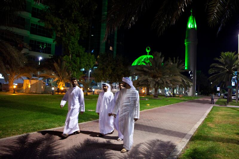 Men walk from their prayers at a mosque in the Khalidiya neighborhood in Abu Dhabi on Tuesday, August 2, 2011, the second day of Ramadan. The last evening prayer traditionally attracts the most people as there are extra prayers prescribed in observation of the holy month of Ramadan. (Silvia Razgova/The National)

