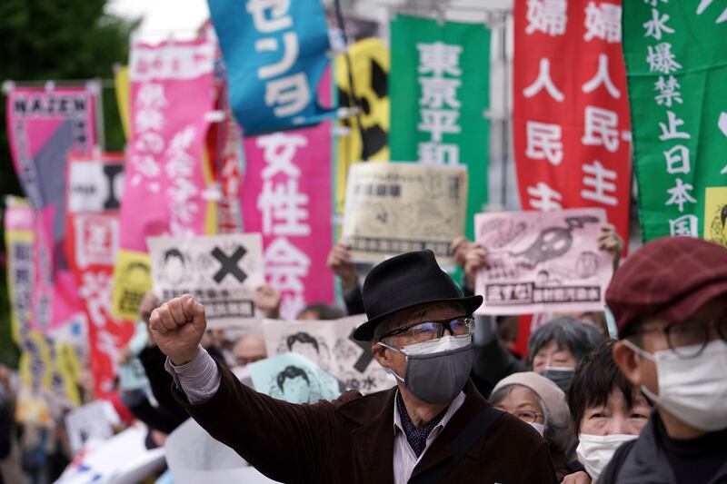 People chant slogans against government's decision to start releasing massive amounts of treated radioactive water from the wrecked Fukushima nuclear plant into the sea, during a rally outside the prime minister's office in Tokyo. AP