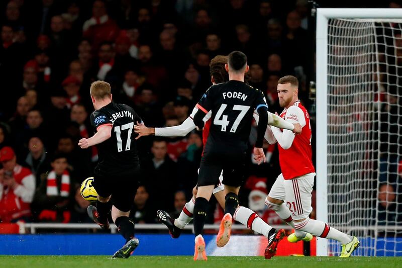 Manchester City midfielder Kevin De Bruyne, left, scores the third goal against Arsenal at the Emirates Stadium in London. AFP