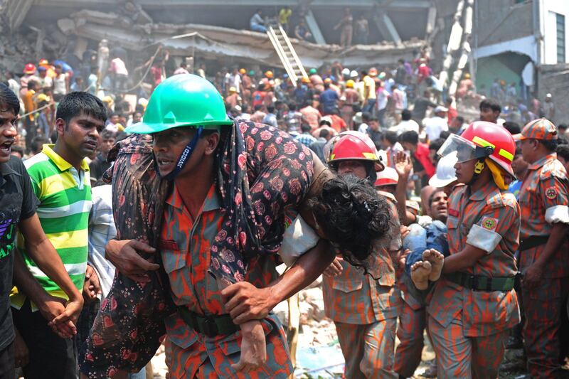 A Bangladeshi firefighter carries an injured garment worker after an eight-storey building collapsed in Savar, on the outskirts of Dhaka, on April 24, 2013. At least 82 people have died and 700 are injured after a eight-storey building housing several garment factories collapsed on the outskirts of Bangladesh's capital on Wednesday, a doctor said. AFP PHOTO/Munir uz ZAMAN
 *** Local Caption ***  978977-01-08.jpg