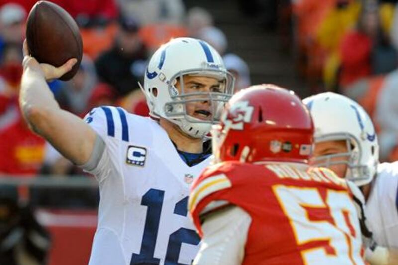 Indianapolis quarterback Andrew Luck lines up a pass while under pressure from Kansas City's Justin Houston.