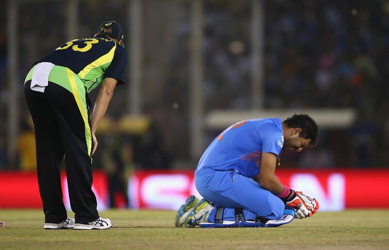 MOHALI, INDIA - MARCH 27:  Yuvraj Singh of India injuires his ankle as Shane Watson of Australia looks on during the ICC WT20 India Group 2 match between India and Australia at I.S. Bindra Stadium on March 27, 2016 in Mohali, India.  (Photo by Ryan Pierse/Getty Images)
