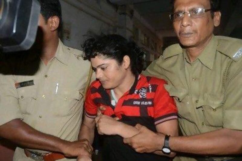 Police escort former Indian athlete Pinki Pramanik to the Barasat District court in near Kolkata. She appeared in court charged with raping her former lover who has alleged that she is actually a man.