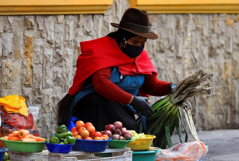 A street seller wears a mask in Riobamba, Ecuador.  EPA