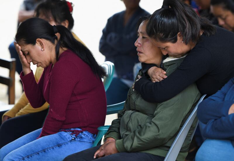 Yolanda Olivares is comforted by a relative during a Mass for the migrants who died in the lorry. Ms Olivares believes her sons Jair, 19, Yovani, 16, and her nephew Misael, 16, are among the migrants who died in the stifling lorry. Reuters