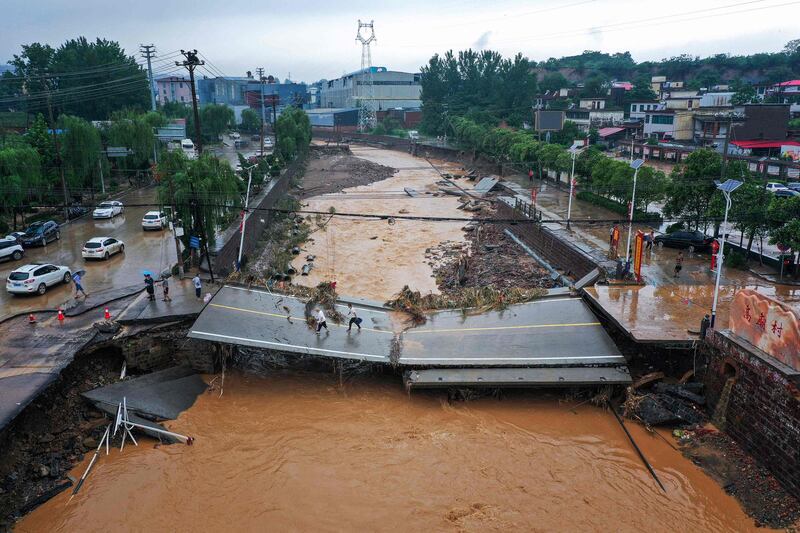 This aerial photo taken show a damaged bridge following heavy rains which caused severe flooding in Gongyi in China's central Henan province.