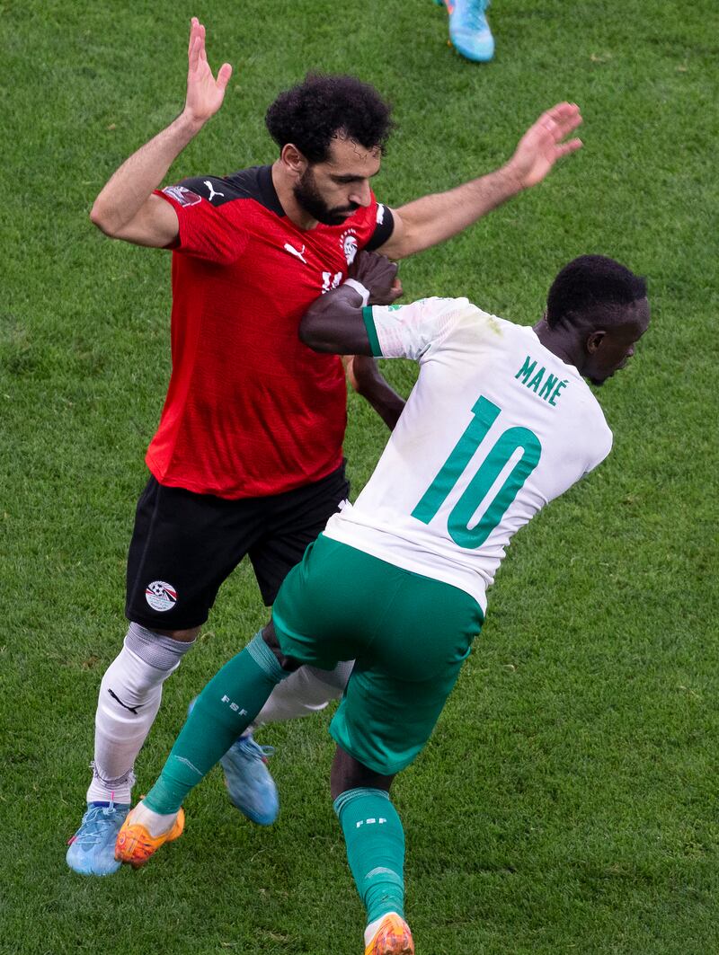 Mohamed Salah, left, is challenged by Sadio Mane at the Stade Me Abdoulaye Wade stadium in Dakar. AP