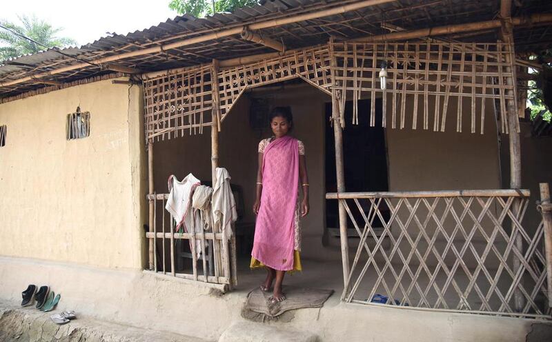 Sorumai Saura, the widow of an alleged poacher who was killed by a forest guard, stands outside her home in a village on the edge of Kaziranga National Park, some 250km east of Guwahati.