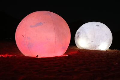 Mock-ups of Mars and the Moon at Not a Space Al Faya desert pop-up in Sharjah. Chris Whiteoak / The National