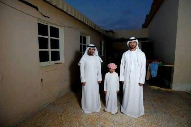 (From left): Brothers Abdullah Alhebsi, 26, Sultan Alhebsi, 8, and Waleed Alhebsi, 29, are photographed in the courtyard of their childhood home in Ras Al Khaimah. Sarah Dea / The National