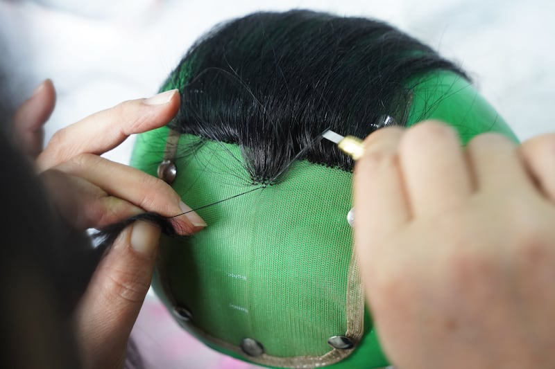 An employee makes a wig at a factory in Shijiazhuang, China. Getty Images