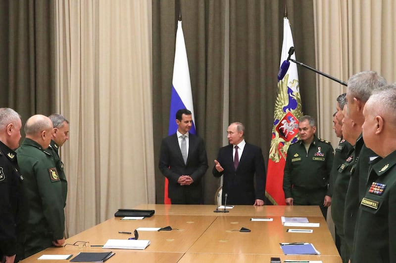 Syrian President Bashar Assad, center left, with Mr Putin and  Russian defence minister Sergei Shoigu, centre right, and other Russian military officials. Mikhail Klimentyev / Kremlin Pool Photo via AP