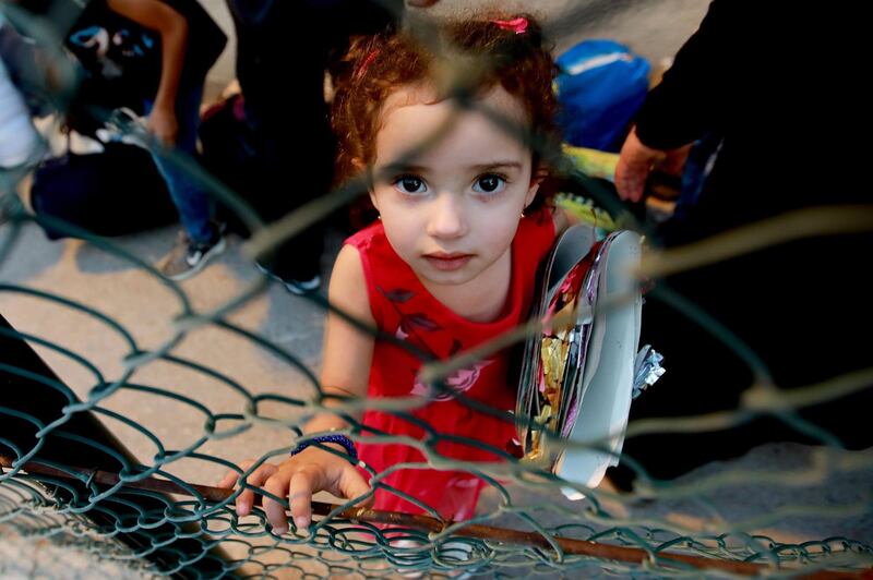 A young Syrian refugee waits as her family prepare to leave the Lebanese capital Beirut to return to their homes.  AFP
