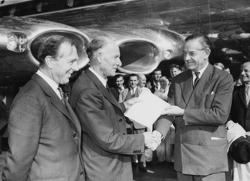 British aircraft engineer Geoffrey de Havilland (1882 - 1965, centre) hands over the articles of a new Comet IV jet airliner to Sir Gerard d'Erlanger (right), Chairman of BOAC (British Overseas Airways Corporation), at London Airport, 30th September 1958. On the left is Aubrey F. Burke, Managing Director of the de Havilland Aircraft Manufacturing Company. (Photo by J. Wilds/Keystone/Hulton Archive/Getty Images)