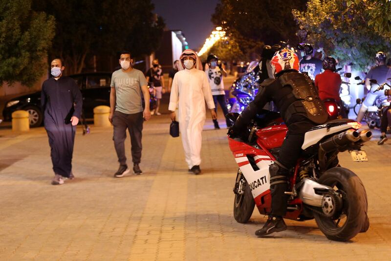 A Saudi youth rides his motorbike on Tahlia Street as nightlife returns after the government eased restrictions imposed to prevent the spread of the coronavirus, in Riyadh, Saudi Arabia. Reuters