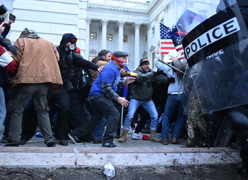 Trump supporters clash with police and security forces as they storm the US Capitol in Washington on January 6, 2021.  AFP