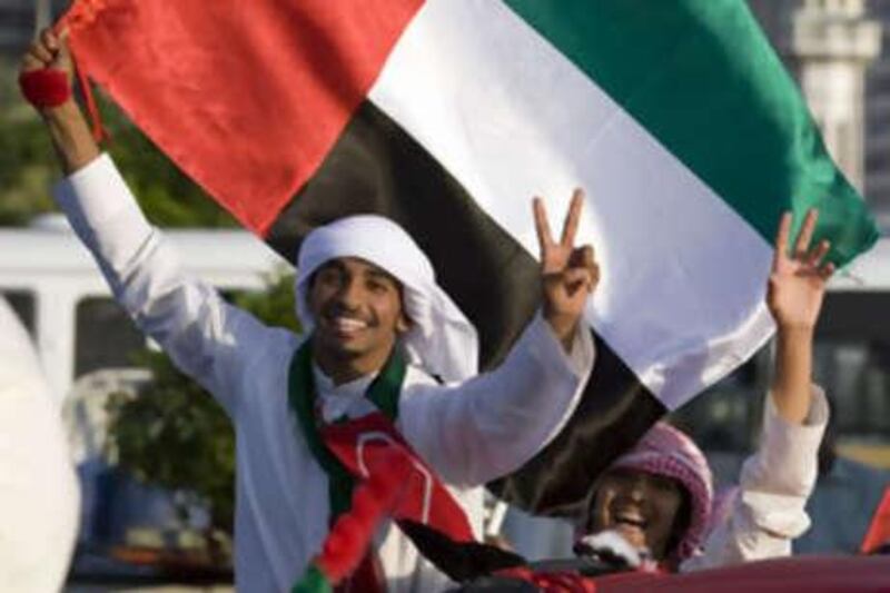 Revellers show their pride during the car parade on the Corniche during the 37th National Day festivities in Abu Dhabi.