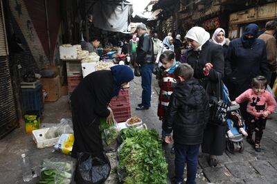 epa08920697 Syrians buy their daily basic food items and other necessities in one of the streets of Damascus, Syria, 05 January 2021.  EPA/YOUSSEF BADAWI