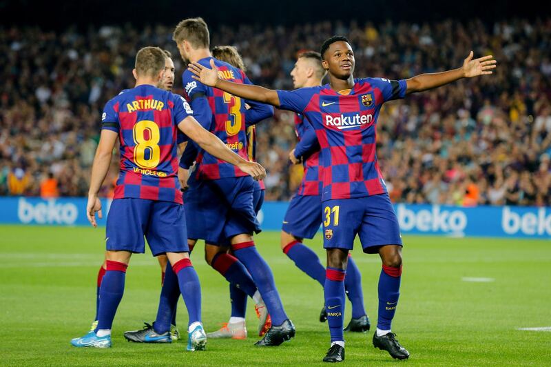 Barcelona´s Guinea-Bissau forward Ansu Fati (R) celebrates after scoring a goal during the Spanish league football match FC Barcelona against Valencia CF at the Camp Nou stadium in Barcelona on September 14, 2019. / AFP / PAU BARRENA
