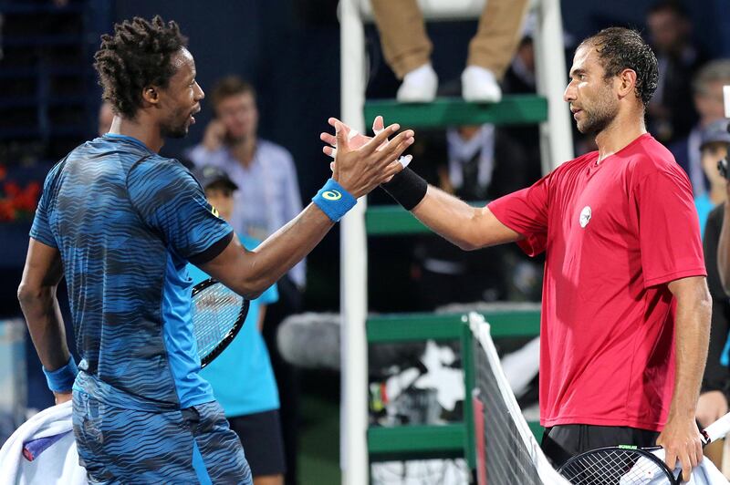 France's Gael Monfils (L) shakes hands with Egypt's Mohamed Safwat after winning his ATP tennis match as part of the Dubai Duty Free Championships on February 27, 2017.
 / AFP / MAHMOUD KHALED        (Photo credit should read MAHMOUD KHALED/AFP/Getty Images)