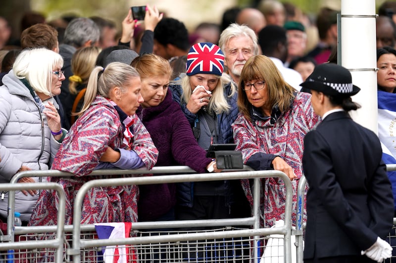 Members of the public watch the funeral from Horse Guards Road in London. PA