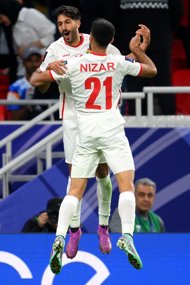 Yazan Al Naimat of Jordan celebrates scoring the opening goal with Nizar Al Rashdan. Getty Images