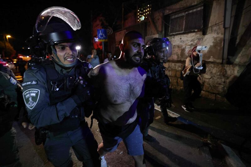 A Palestinian protester is arrested in front of an Israeli settler's house in East Jerusalem during a demonstration as Palestinian families face eviction. AFP